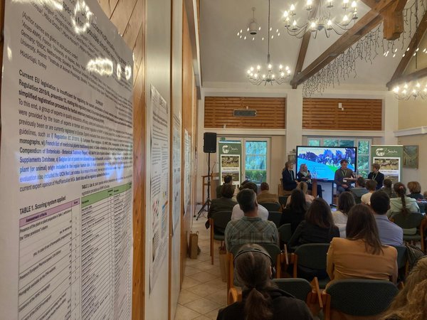 Participants at an event listen to a speaker.