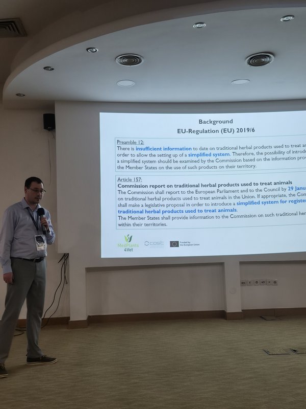 Man giving a lecture in front of a screen.